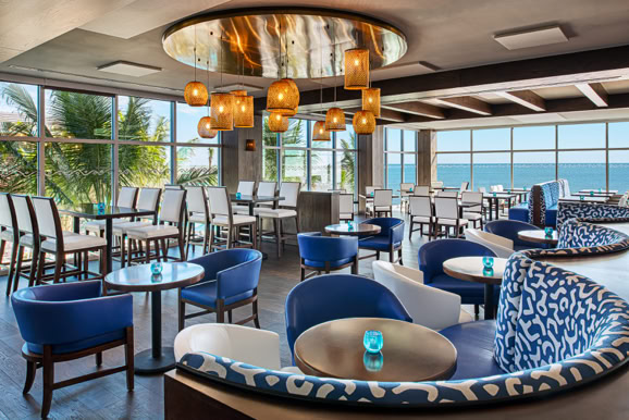 Restaurant interior highlighting seating layout, lighting design, and atmosphere within a resort setting.