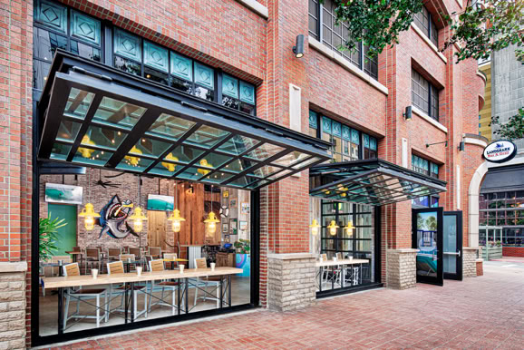 Street-level hospitality space featuring storefront design and integration within an urban environment.