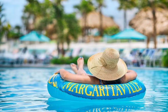 Guest relaxing poolside capturing leisure, comfort, and tropical resort atmosphere.
