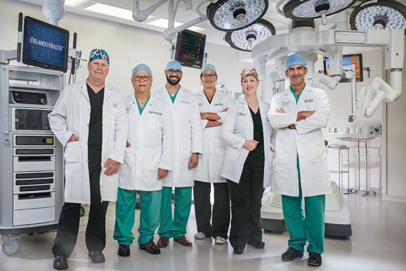 Medical team portrait within a surgical environment highlighting professionalism and expertise.
