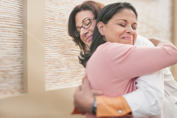 Emotional moment of care and reassurance, emphasizing human connection within healthcare environments.